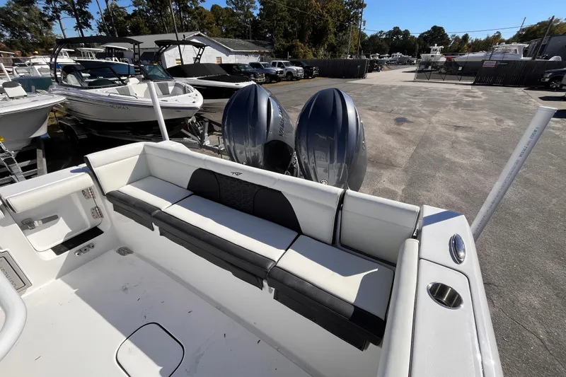  Yacht Photos Pics 2026 Tidewater 256 LXF boat with dual engines and spacious seating in a marina setting.