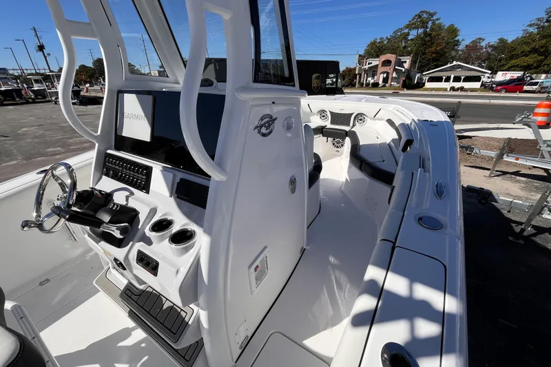  Yacht Photos Pics 2026 Tidewater 256 LXF boat interior with Garmin navigation system and sleek design.