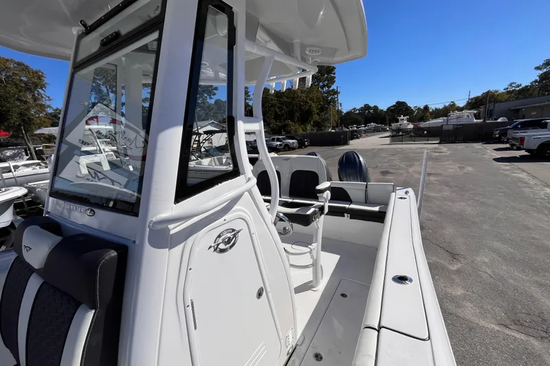  Yacht Photos Pics 2026 Tidewater 256 LXF boat with sleek design and modern features, docked outdoors.