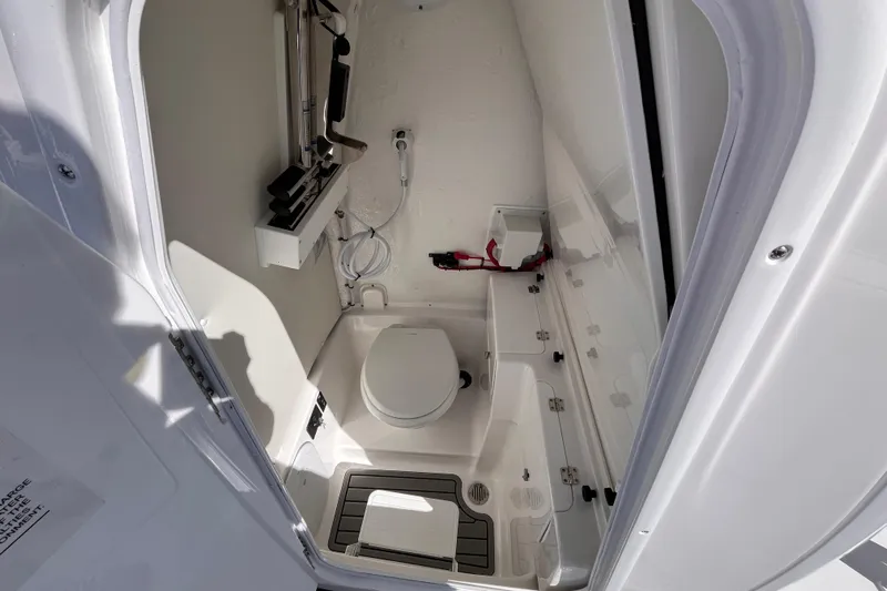  Yacht Photos Pics 2026 Tidewater 256 LXF boat interior bathroom with toilet and storage.
