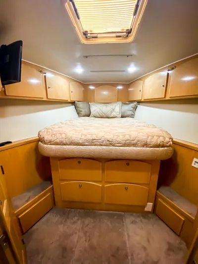 Boom Yacht Photos Pics Cozy bedroom in 1999 Navigator 5800 yacht with wood cabinets and skylight.