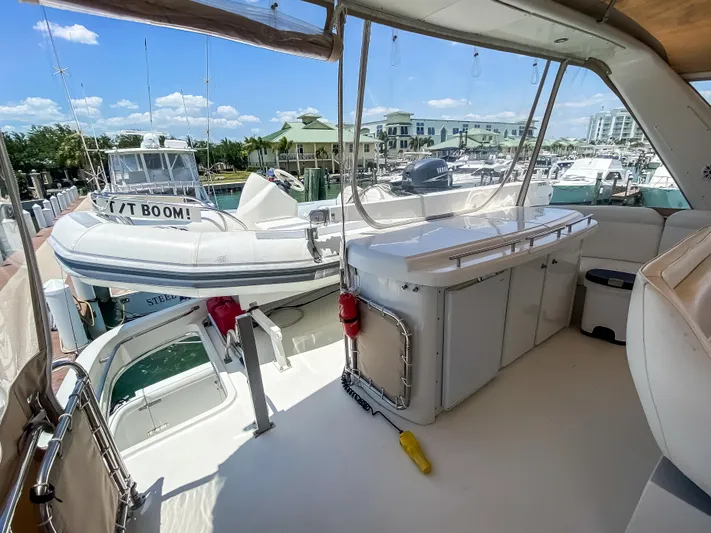 Boom Yacht Photos Pics Navigator 5800 yacht interior with marina view, featuring seating and a small boat.