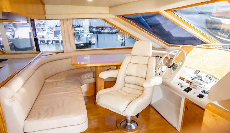 Boom Yacht Photos Pics Luxurious interior of a 1999 Navigator 5800 yacht with leather seating and helm.