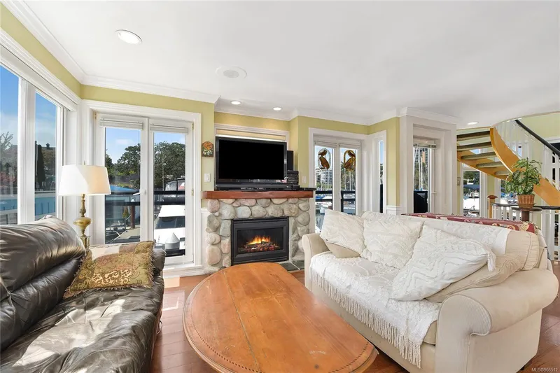  Yacht Photos Pics Cozy living room in a 2005 custom float home with fireplace and large windows.