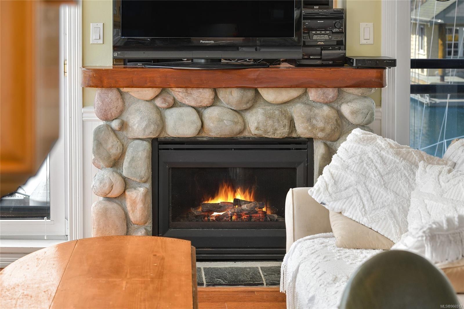 Cozy stone fireplace in a 2005 custom float home living room.