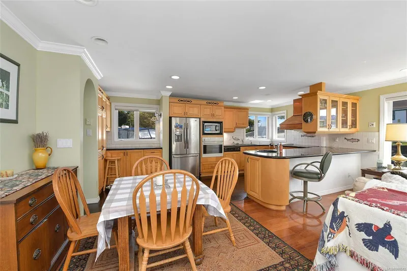  Yacht Photos Pics Cozy kitchen and dining area in a 2005 custom float home with wooden cabinetry and modern appliances.