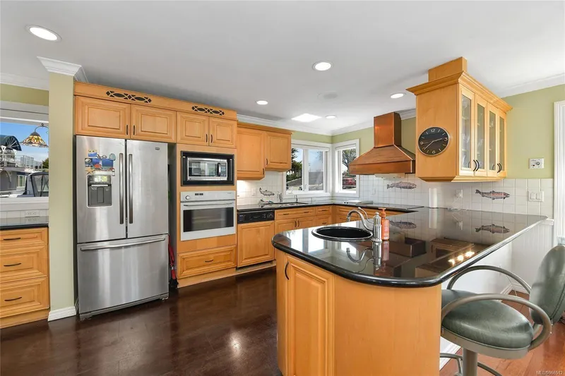  Yacht Photos Pics Spacious kitchen in custom 2005 float home with wooden cabinets and modern appliances.