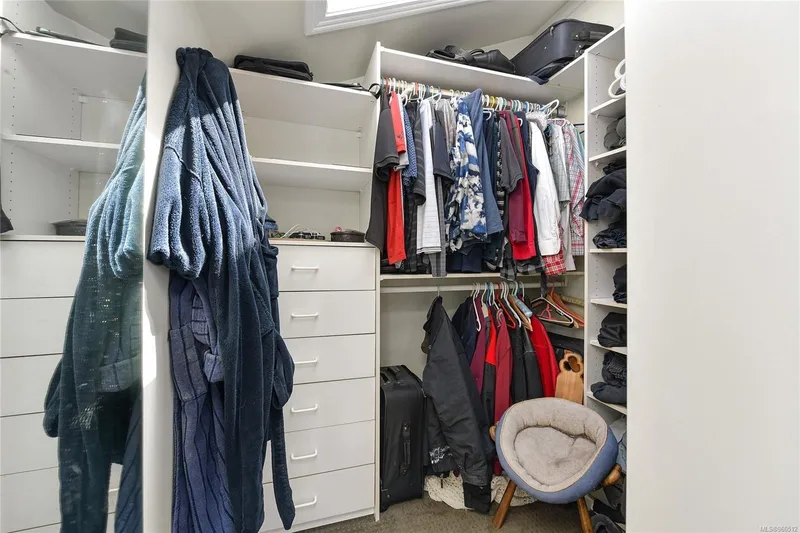  Yacht Photos Pics Walk-in closet with clothes, shelves, and a chair in a 2005 Custom Float Home.