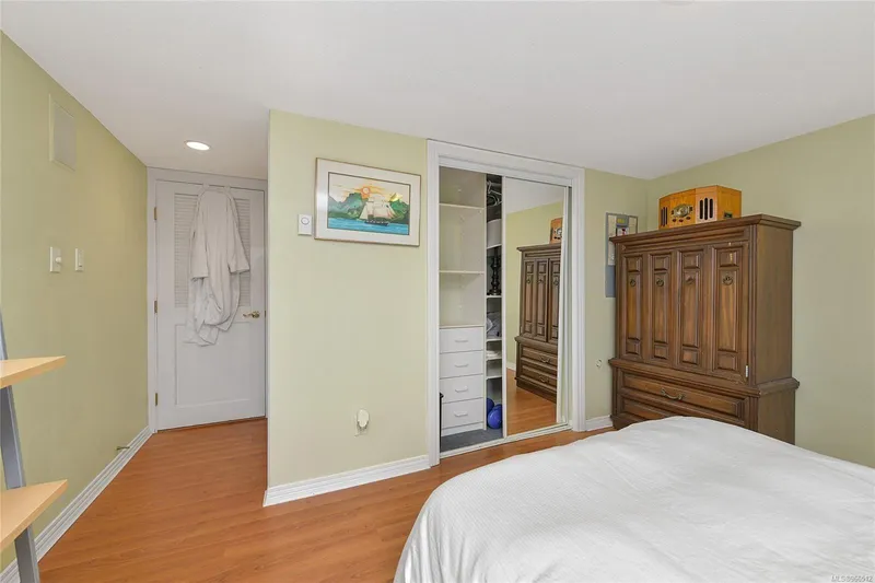  Yacht Photos Pics Bedroom in a 2005 custom float home with wooden furniture and closet.