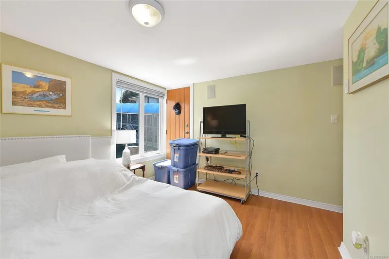  Yacht Photos Pics Cozy bedroom in 2005 custom float home with TV, window view, and wooden flooring.