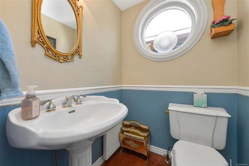  Yacht Photos Pics Small bathroom with pedestal sink, oval window, and decorative mirror in a 2005 custom float home.