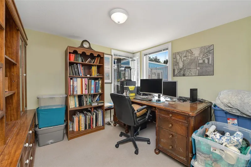  Yacht Photos Pics Home office with wooden desk, bookshelves, and dual monitors in a 2005 Custom Float Home.