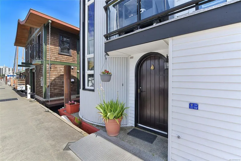  Yacht Photos Pics Custom 2005 float home with modern design, potted plants, and waterfront view.