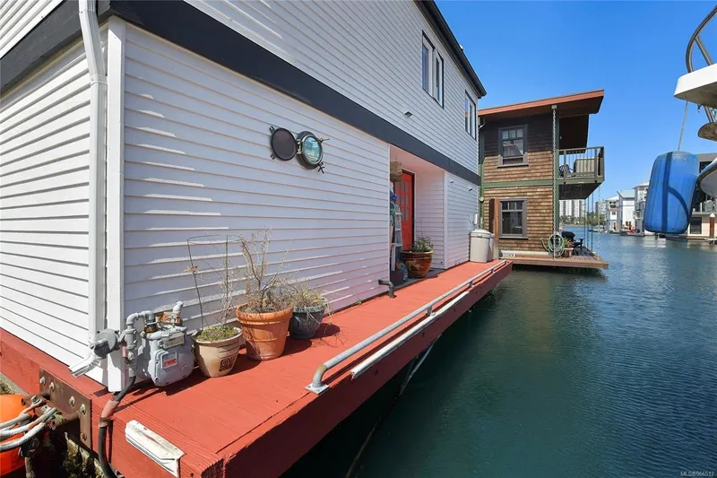  Yacht Photos Pics Floating home with red deck, potted plants, and waterfront view. Custom model, 2005.