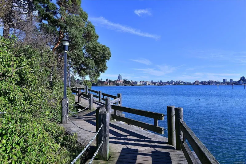  Yacht Photos Pics Scenic waterfront boardwalk with lush greenery and clear blue sky, near a Custom Float Home.