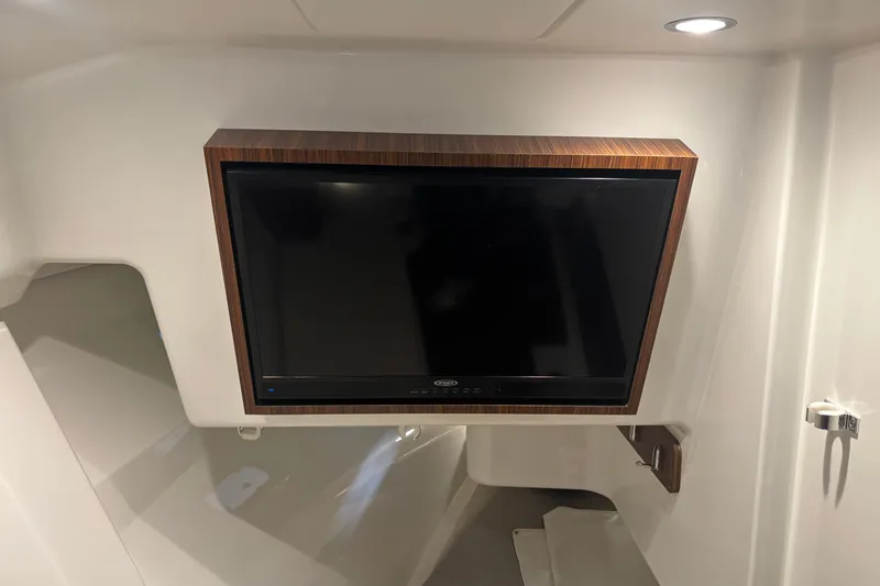 Yacht Photos Pics 2020 Pursuit DC 365 Dual Console interior with mounted TV and modern lighting.