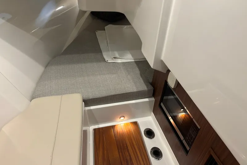  Yacht Photos Pics 2020 Pursuit DC 365 Dual Console interior with cushioned seating and wood accents.