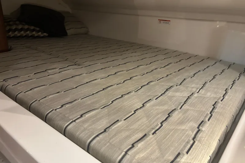  Yacht Photos Pics 2020 Pursuit DC 365 Dual Console cabin with striped bedding and pillows.