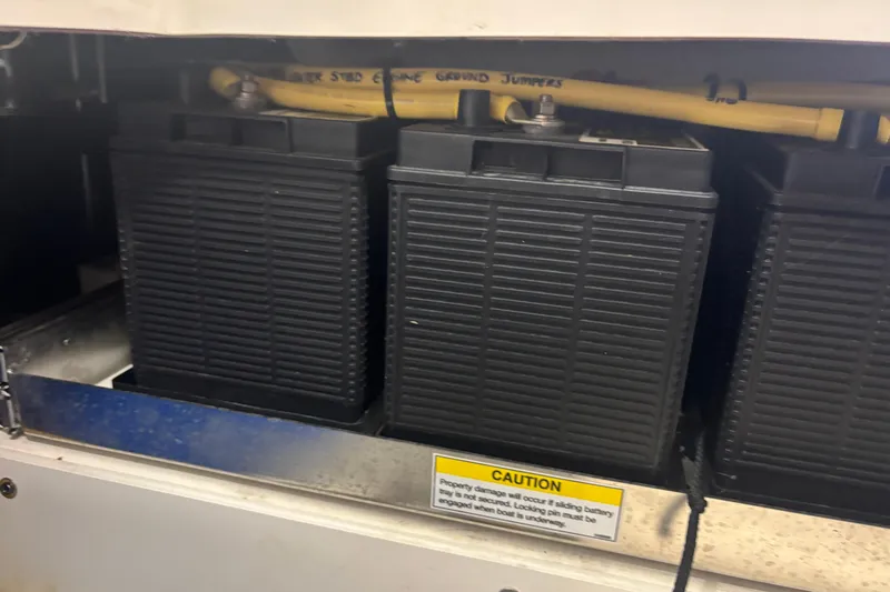  Yacht Photos Pics Battery compartment of a 2020 Pursuit DC 365 Dual Console boat with caution label.