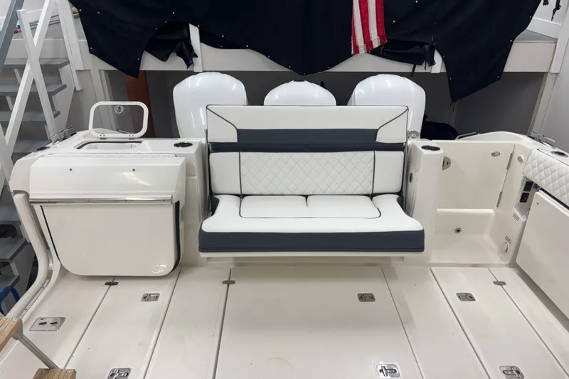  Yacht Photos Pics 2020 Pursuit DC 365 Dual Console boat interior with seating and storage compartments.