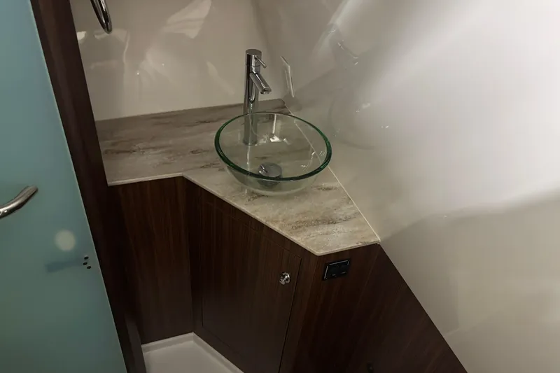  Yacht Photos Pics 2020 Pursuit DC 365 Dual Console bathroom with glass sink and modern faucet.