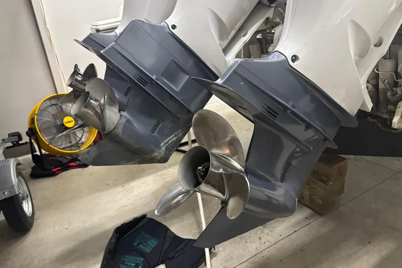  Yacht Photos Pics 2020 Pursuit DC 365 Dual Console boat propellers in a garage setting.