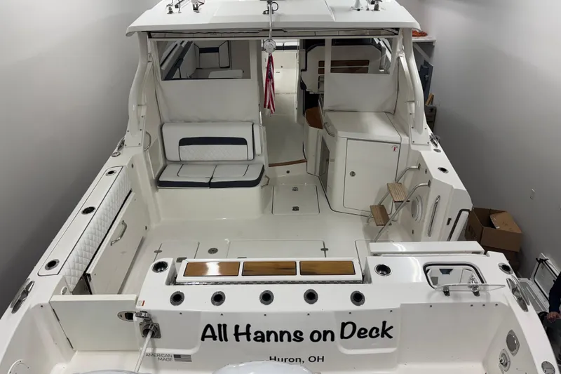  Yacht Photos Pics 2020 Pursuit DC 365 Dual Console boat interior, named "All Hanns on Deck," in a garage.