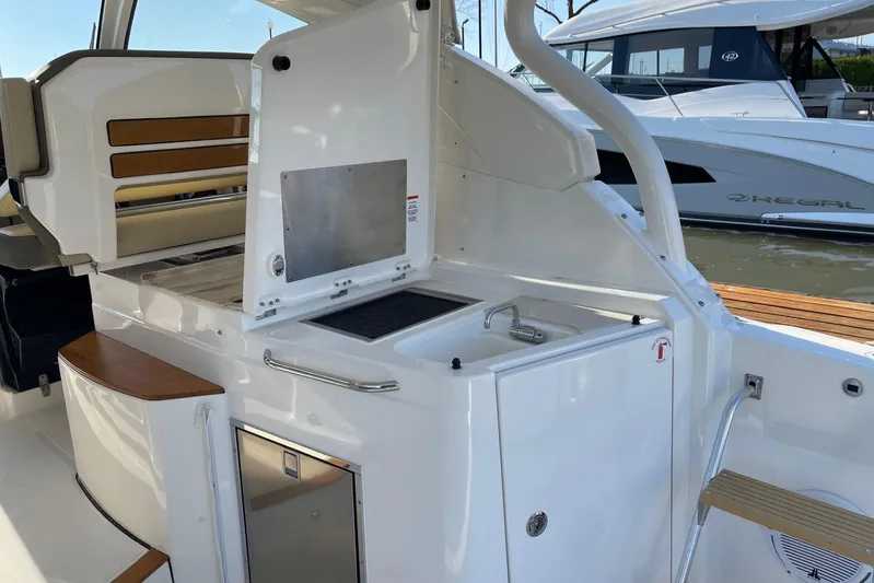  Yacht Photos Pics 2020 Pursuit DC 365 Dual Console boat interior with kitchenette and seating area.