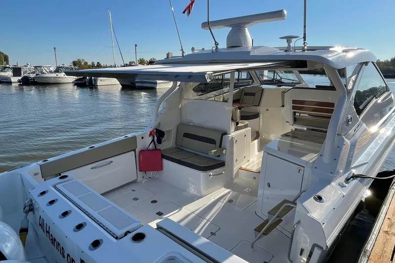 Yacht Photos Pics 2020 Pursuit DC 365 Dual Console boat docked, featuring spacious seating and modern design.