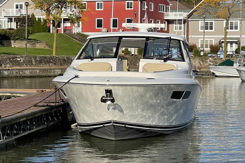  Yacht Photos Pics 2020 Pursuit DC 365 Dual Console boat docked in a scenic marina setting.