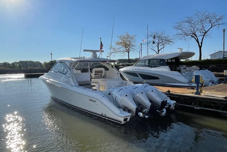  Yacht Photos Pics 2020 Pursuit DC 365 Dual Console boat docked in sunny marina setting.