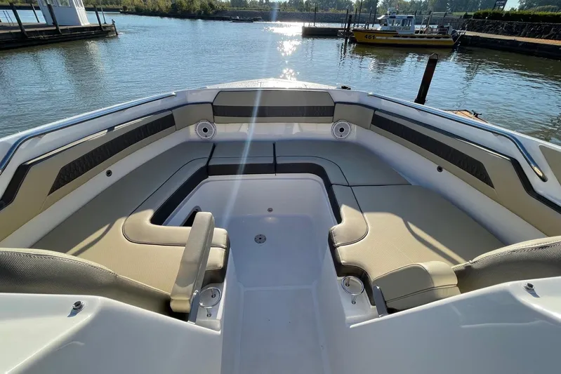  Yacht Photos Pics 2020 Pursuit DC 365 Dual Console boat interior with spacious seating, docked by calm waters.