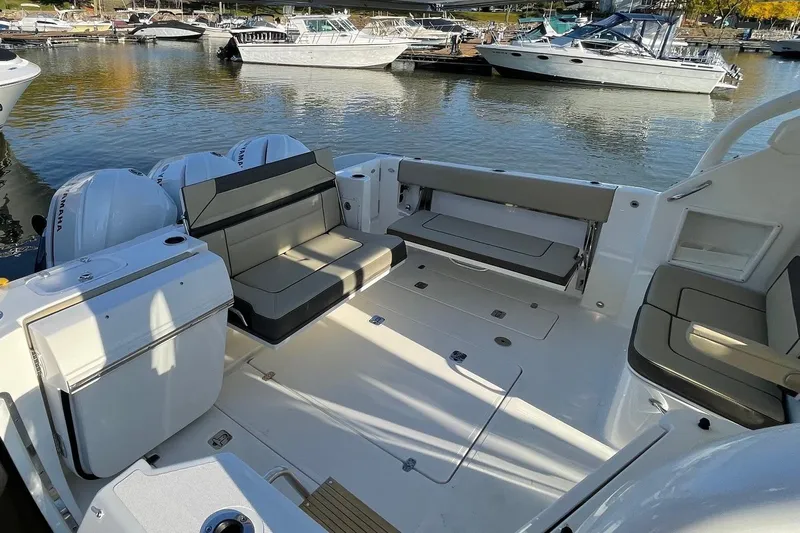  Yacht Photos Pics 2020 Pursuit DC 365 Dual Console boat interior with seating, docked at marina.