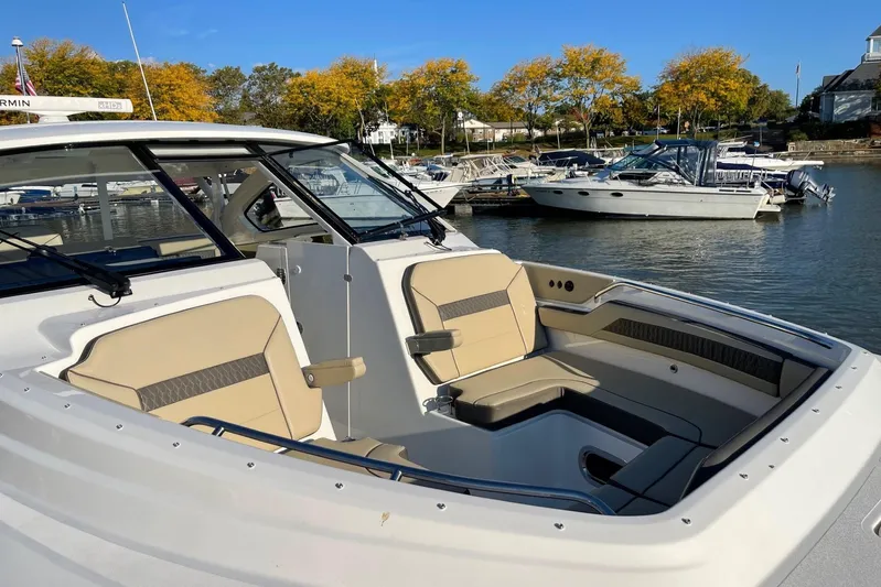  Yacht Photos Pics 2020 Pursuit DC 365 Dual Console boat docked in a marina with autumn trees.