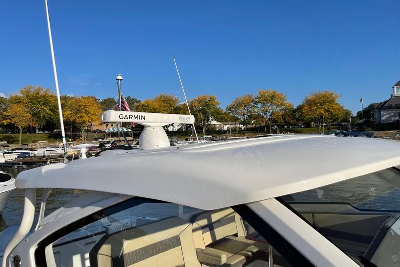  Yacht Photos Pics 2020 Pursuit DC 365 Dual Console boat with Garmin radar, docked near autumn trees.