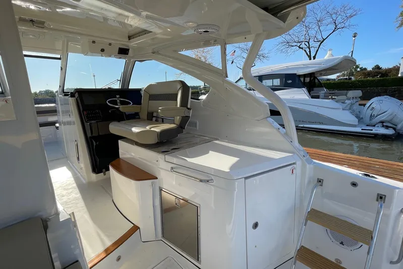  Yacht Photos Pics 2020 Pursuit DC 365 Dual Console boat interior with helm seat and cabinetry.