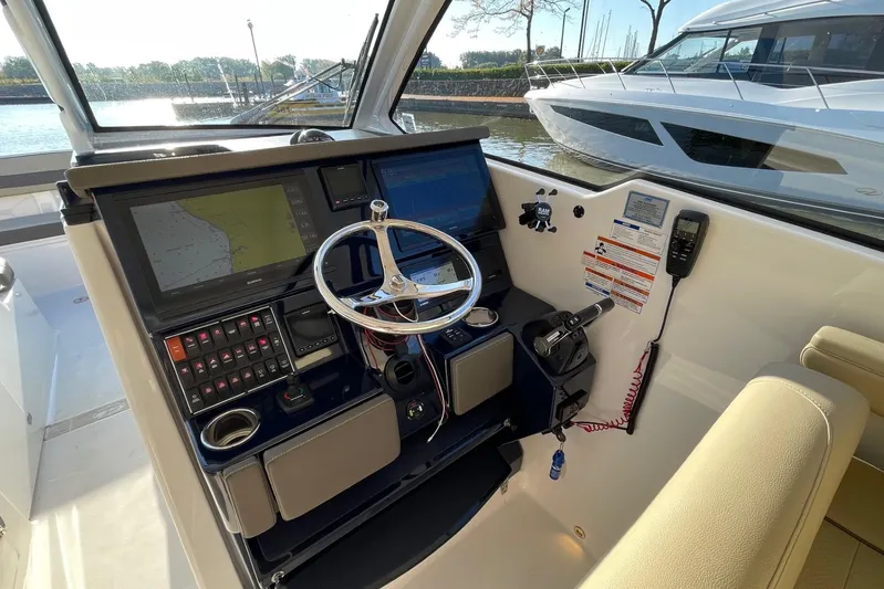  Yacht Photos Pics 2020 Pursuit DC 365 Dual Console helm with navigation screens and steering wheel.