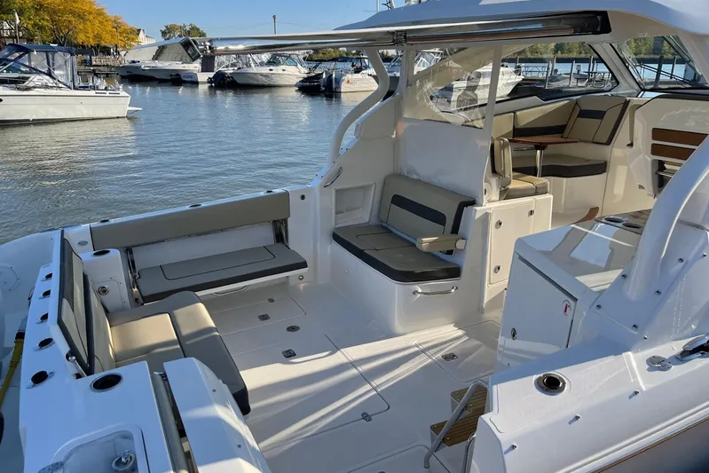  Yacht Photos Pics 2020 Pursuit DC 365 Dual Console boat interior with seating, docked in a marina.
