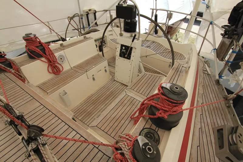 Le Reve Yacht Photos Pics Cockpit of 1983 Nautor Swan 46mkI sailboat with wooden deck and red ropes.