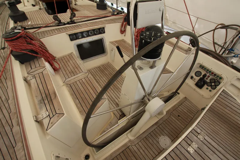 Le Reve Yacht Photos Pics Cockpit of 1983 Nautor Swan 46mkI sailboat with wooden deck and steering wheel.