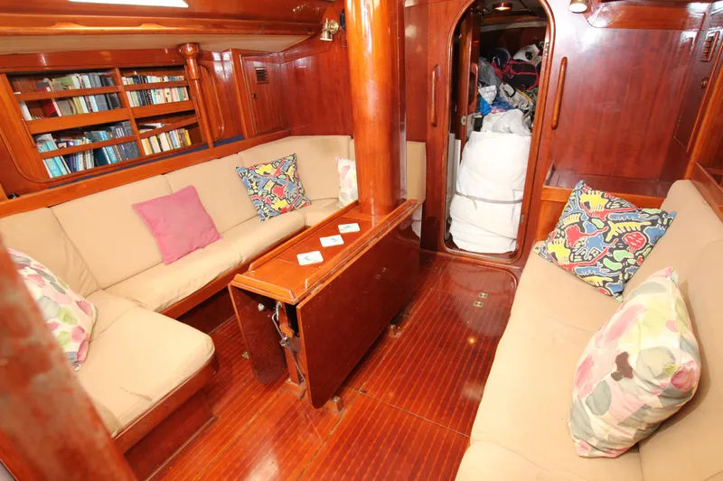 Le Reve Yacht Photos Pics Cozy interior of 1983 Nautor Swan 46mkI yacht with wooden finish and colorful cushions.
