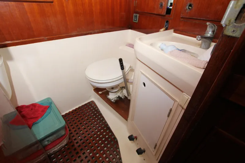Le Reve Yacht Photos Pics Bathroom interior of 1983 Nautor Swan 46mkI yacht, featuring toilet and sink.