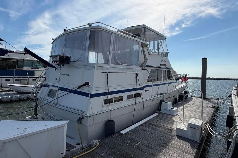 Frayed Knot Yacht Photos Pics 1987 Viking 44 Motor Yacht docked at marina under clear blue sky.