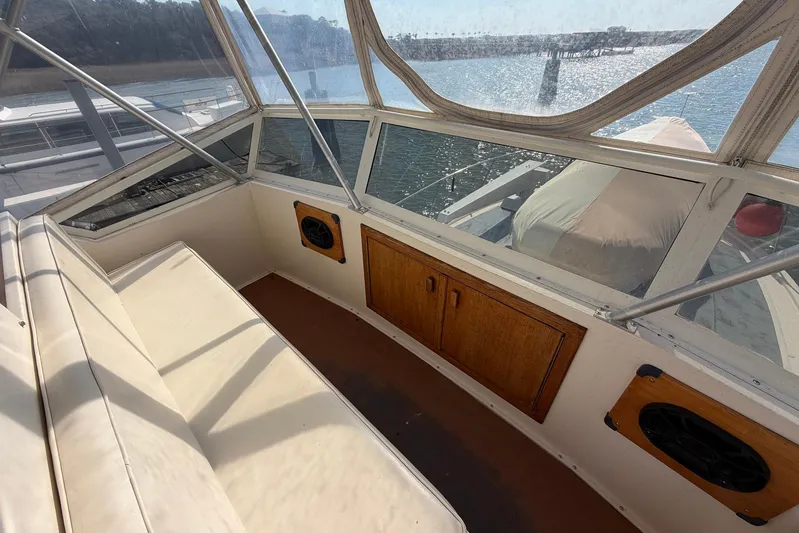 Frayed Knot Yacht Photos Pics 1987 Viking 44 Motor Yacht interior with seating, wooden cabinets, and waterfront view.