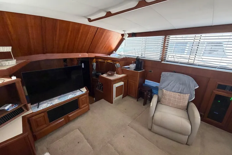 Frayed Knot Yacht Photos Pics Interior of 1987 Viking 44 Motor Yacht with wood paneling and comfortable seating.