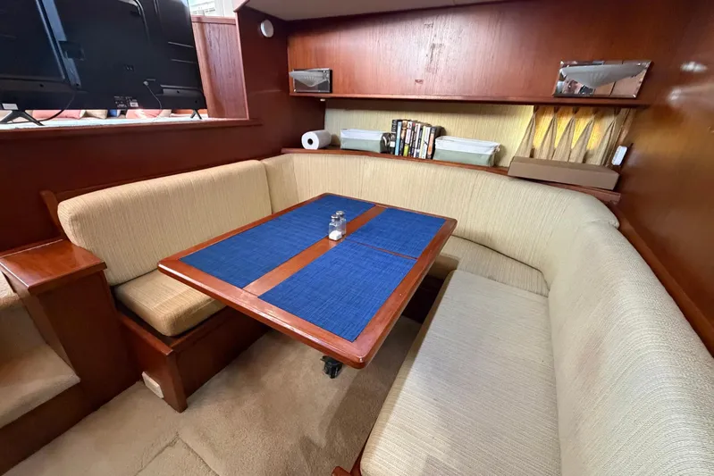 Frayed Knot Yacht Photos Pics 1987 Viking 44 Motor Yacht interior with cozy dining area and wooden accents.
