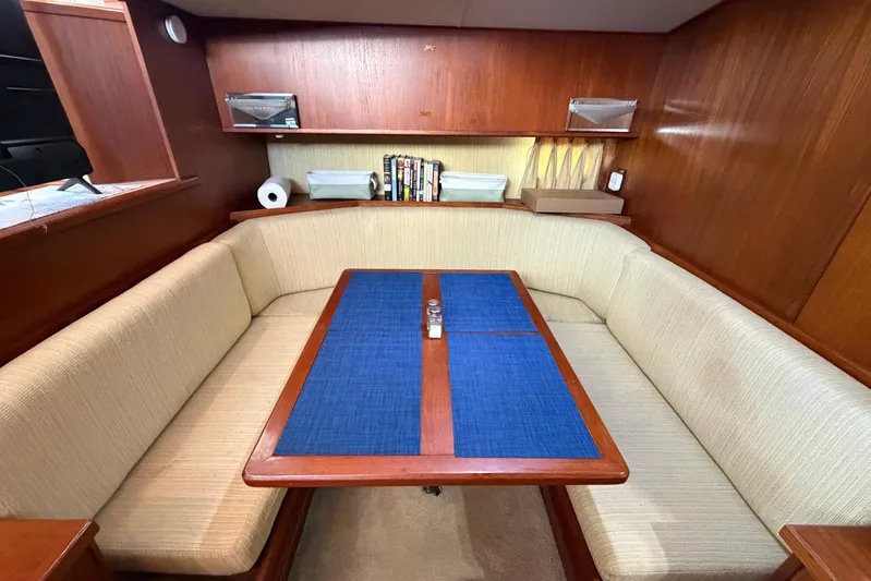 Frayed Knot Yacht Photos Pics 1987 Viking 44 Motor Yacht interior with cozy dining area and wooden accents.