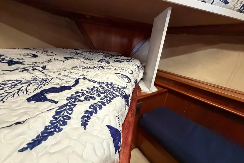 Frayed Knot Yacht Photos Pics Interior of 1987 Viking 44 Motor Yacht with patterned bedding and wooden accents.