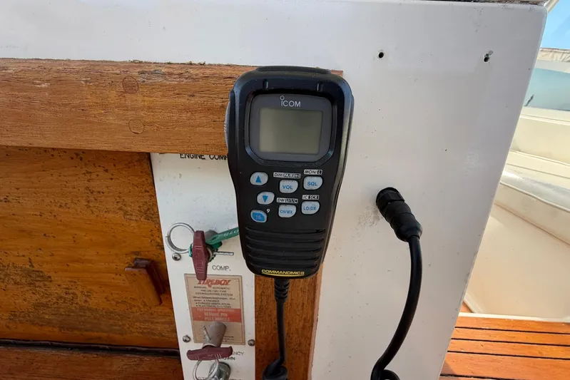 Frayed Knot Yacht Photos Pics ICOM radio on 1987 Viking 44 Motor Yacht, mounted on wooden panel.