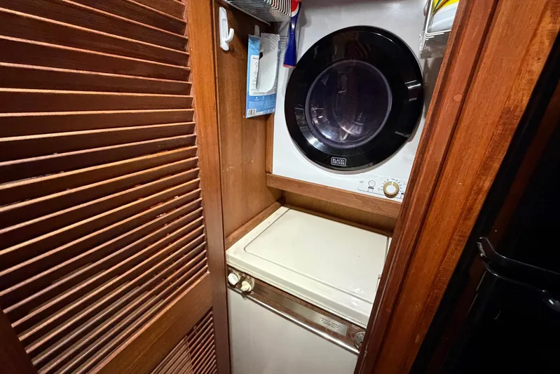 Frayed Knot Yacht Photos Pics Laundry area in 1987 Viking 44 Motor Yacht with washer and dryer.